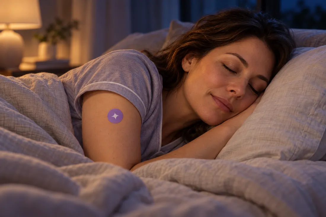 A woman asleep in bed at night wearing a Ledisa Sleep Patch on her upper arm